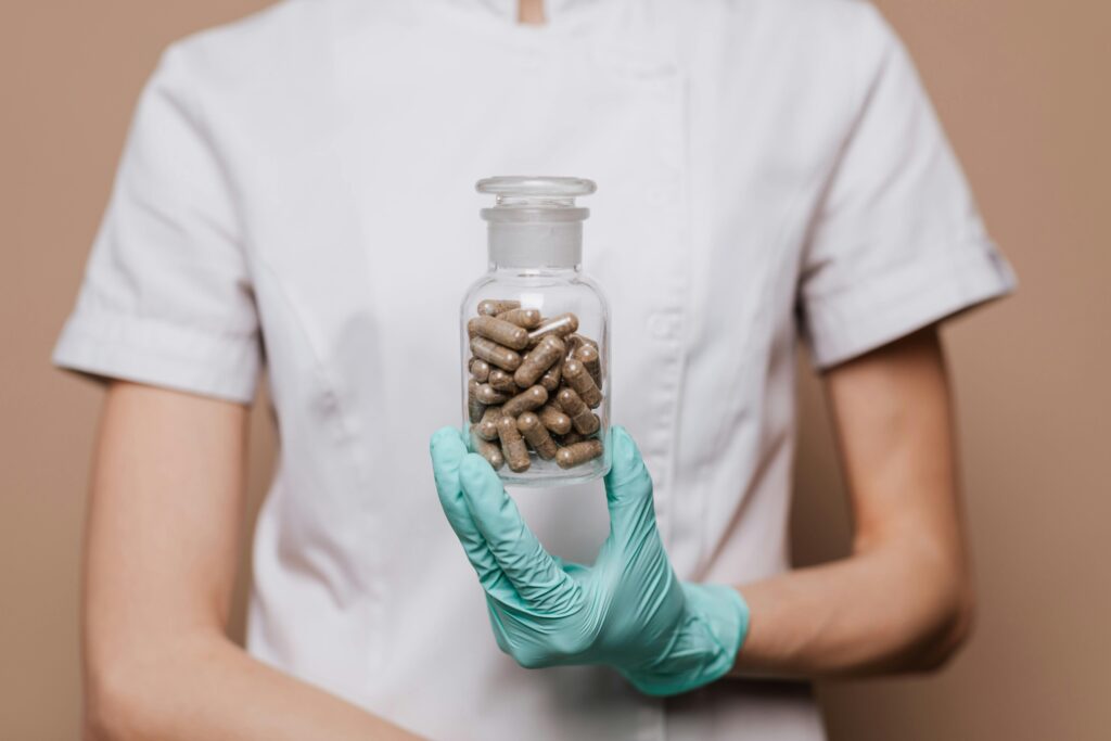 A healthcare worker in gloves holding a bottle of capsules, emphasizing health and medicine.